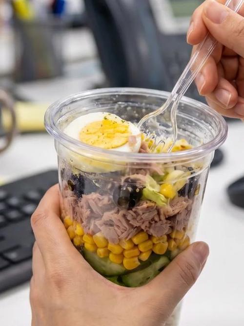 A Salad Cup salad at a desk at lunchtime